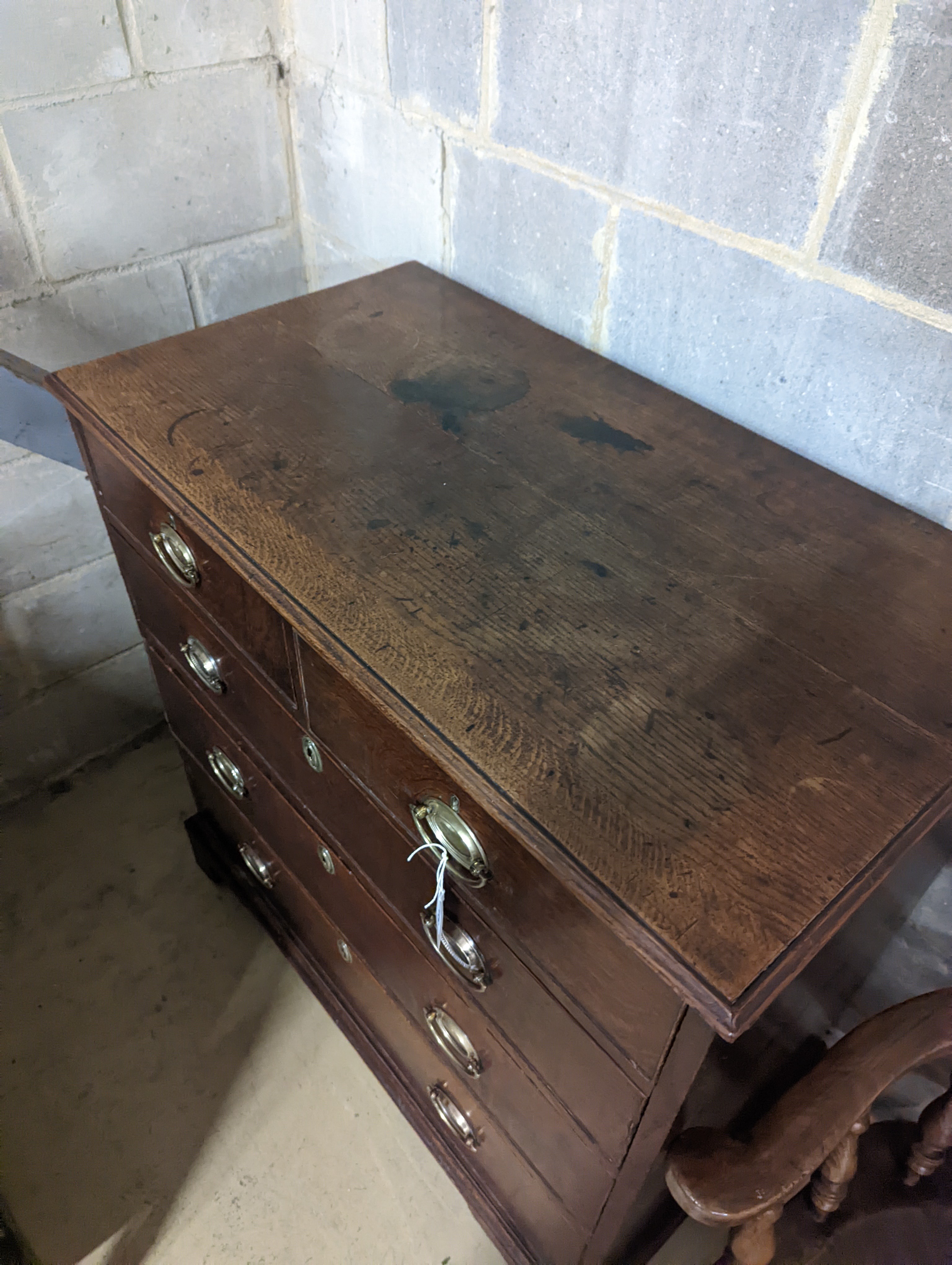 A George III oak chest of two short and three long graduated drawers, . W-94cm, D-51cm, H-99cm.